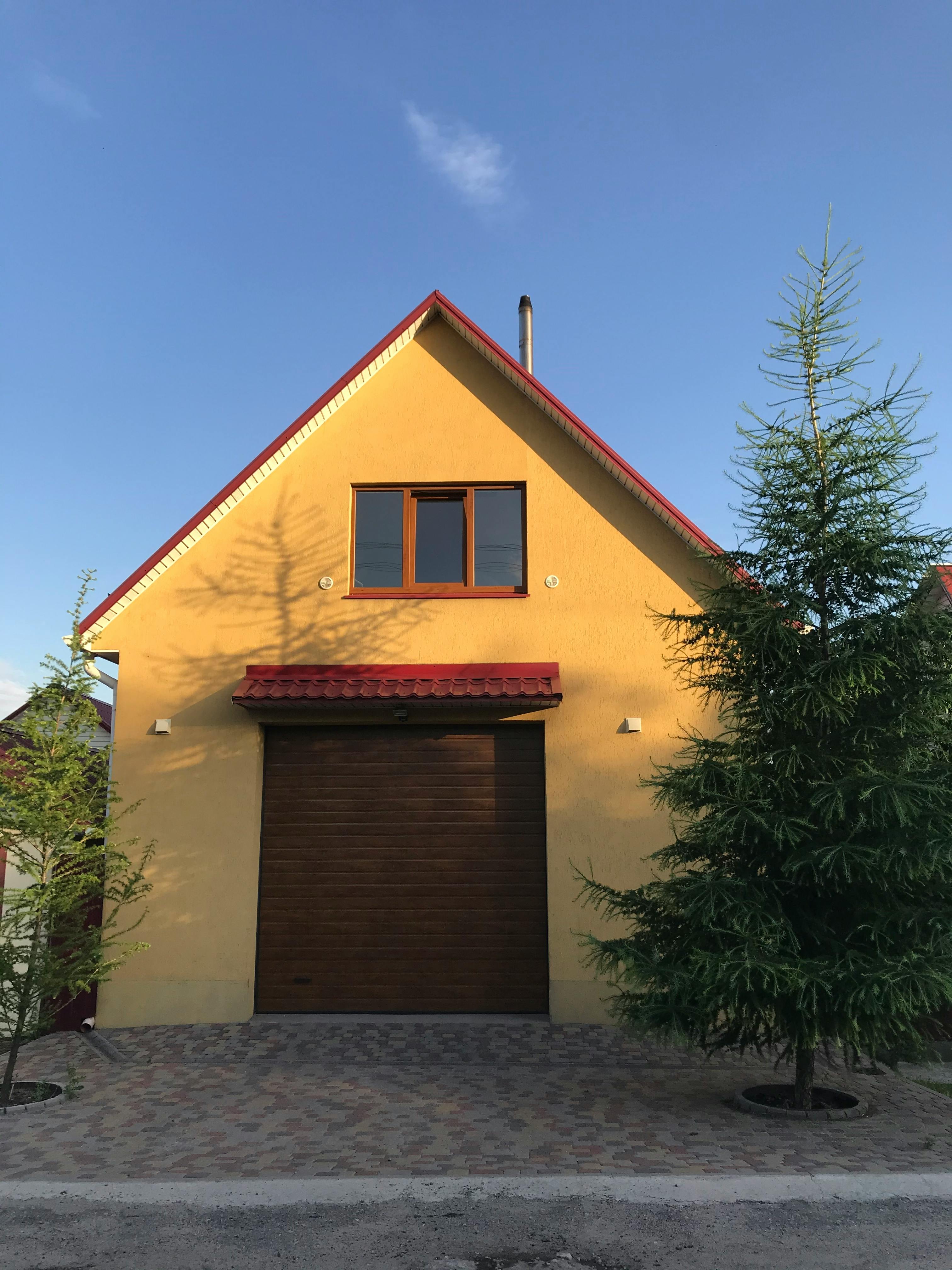 Yellow house with wooden garage door